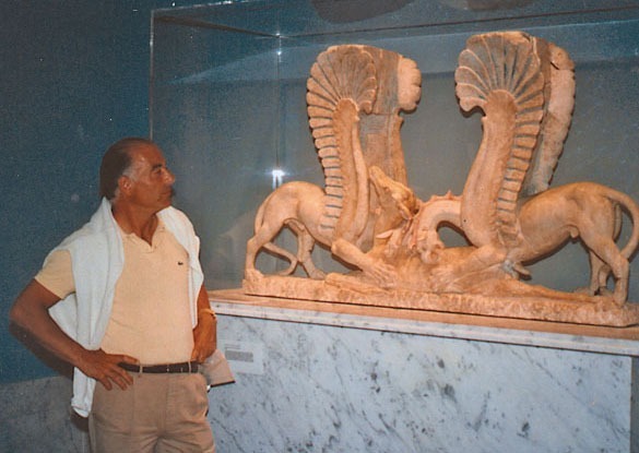 Medici standing in front of the same scupture, now restored, sold and on display in a museum